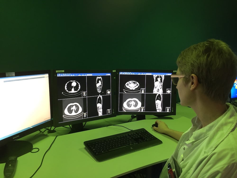 Radiologist sits in green ergonomic lighting from Chromaviso