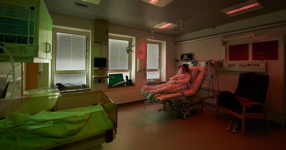 Woman sits with child in maternity ward in ergonomic lighting from Chromaviso