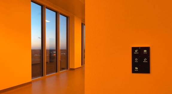 Chromaviso's control panel in a long corridor with amber circadian light in Aabenraa's psychiatry